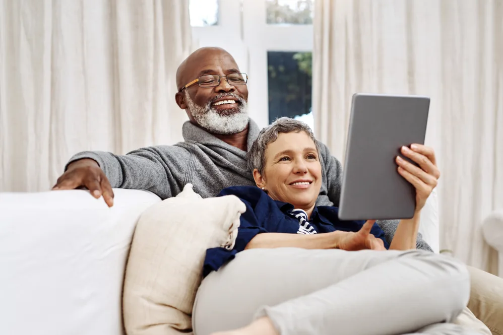 Senior couple on couch on tablet
