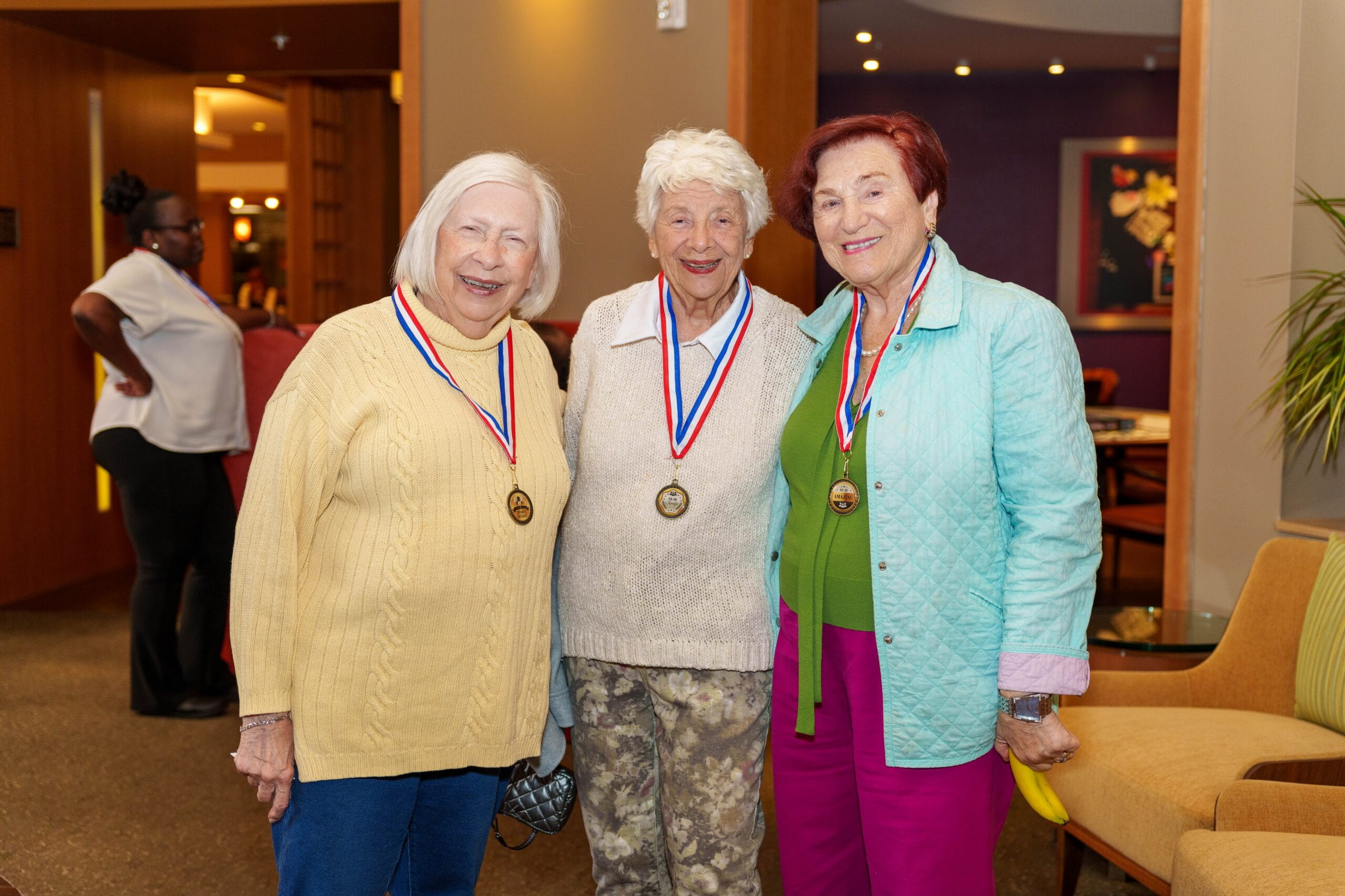 3 women wearing medals at All Seasons senior living community